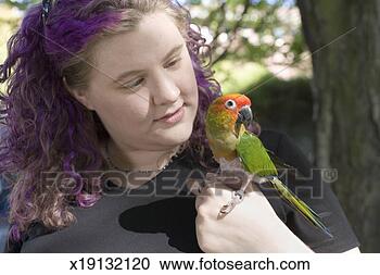 Stock Photography - parrot perched 
on woman's shoulder, 
close-up. fotosearch 
- search stock 
photos, pictures, 
images, and photo 
clipart