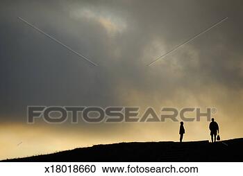 Stock Photography - silhouettes of 
two people standing 
on horizon, dusk. 
fotosearch - search 
stock photos, 
pictures, images, 
and photo clipart