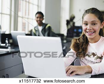 Stock Photo - students (6-12) 
using laptop in 
school laboratory, 
 focus on girl 
in. fotosearch 
- search stock 
photos, pictures, 
images, and photo 
clipart