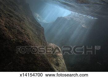 Stock Photography - sunrays penetrating 
underwater cave 
near surface, 
underwater view. 
fotosearch - search 
stock photos, 
pictures, images, 
and photo clipart