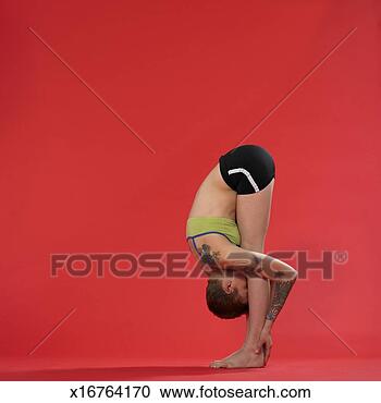 Stock Photography - young woman doing 
yoga, forward 
bend position. 
fotosearch - search 
stock photos, 
pictures, images, 
and photo clipart