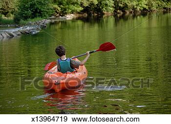 Stock Photograph - boy (12-13) kayaking 
in river, rear 
view. fotosearch 
- search stock 
photos, pictures, 
images, and photo 
clipart