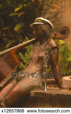 Stock Photo - bronze statue 
of girl sitting 
by musical instruments, 
outdoors. fotosearch 
- search stock 
photos, pictures, 
images, and photo 
clipart