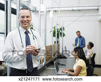 Stock Photography - male doctor in 
reception area 
of medical office, 
 medical. fotosearch 
- search stock 
photos, pictures, 
images, and photo 
clipart