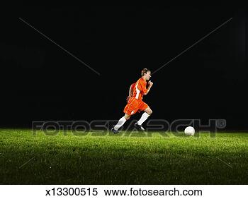 Stock Image - male soccer player 
dribbling soccer 
ball. fotosearch 
- search stock 
photos, pictures, 
images, and photo 
clipart