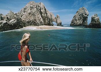 Stock Photo - mexico, baja, 
cabo san lucas, 
woman on boat 
looking at rock 
formations. fotosearch 
- search stock 
photos, pictures, 
images, and photo 
clipart