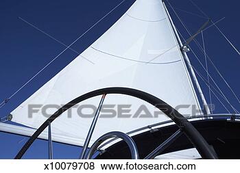 Stock Photo - sail and wheel 
on sailing boat, 
low angle view. 
fotosearch - search 
stock photos, 
pictures, images, 
and photo clipart