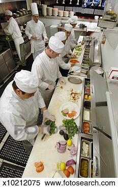 Stock Image - team of chefs 
preparing food, 
elevated view. 
fotosearch - search 
stock photos, 
pictures, images, 
and photo clipart
