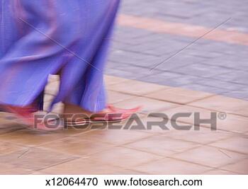 Stock Photography - woman wearing 
traditional dress 
and moroccan shoes, 
low section. fotosearch 
- search stock 
photos, pictures, 
images, and photo 
clipart