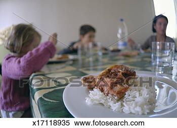 Stock Image - french family 
having lunch at 
home (selective 
focus on meal). 
fotosearch - search 
stock photos, 
pictures, images, 
and photo clipart