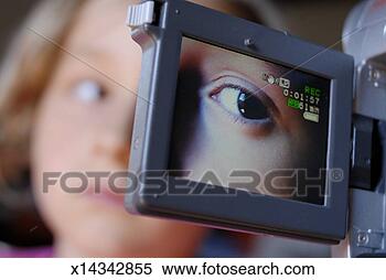 Stock Image - girl (6-7) being 
videotaped, focus 
on camera display 
in foreground. 
fotosearch - search 
stock photos, 
pictures, images, 
and photo clipart
