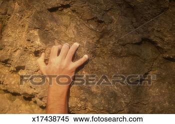 Stock Image - man climbing rock, 
close-up of hand 
grasping for handhold. 
fotosearch - search 
stock photos, 
pictures, images, 
and photo clipart