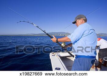 Stock Photograph - man fishing off 
of sport fishing 
boat for tuna. 
fotosearch - search 
stock photos, 
pictures, images, 
and photo clipart