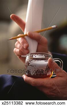 Stock Photo - man holding cup 
and pencil, close-up 
of hands. fotosearch 
- search stock 
photos, pictures, 
images, and photo 
clipart