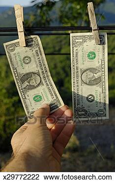 Stock Photo - man touching one 
us dollars banknote 
hanging on clothesline. 
fotosearch - search 
stock photos, 
pictures, images, 
and photo clipart