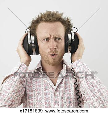 Stock Photograph - man wearing headphones, 
pulling facial 
expression. fotosearch 
- search stock 
photos, pictures, 
images, and photo 
clipart