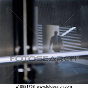 Stock Photo - out of focus man 
walking towards 
stairs, view through 
glass. fotosearch 
- search stock 
photos, pictures, 
images, and photo 
clipart