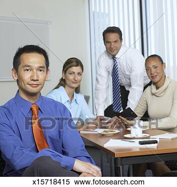 Stock Image - portrait of four 
business people 
in conference 
room, focus on 
one. fotosearch 
- search stock 
photos, pictures, 
images, and photo 
clipart