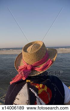 Stock Photograph - senior woman looking 
out over water, 
rear view. fotosearch 
- search stock 
photos, pictures, 
images, and photo 
clipart