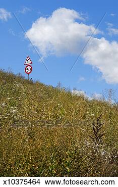 Stock Photo - speed limit and 
curve road signs 
on hill, blue 
sky. fotosearch 
- search stock 
photos, pictures, 
images, and photo 
clipart