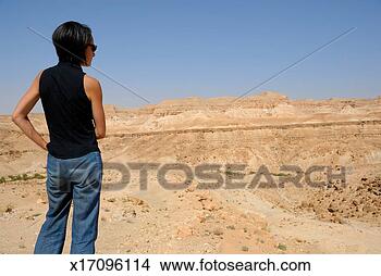 Stock Photo - tunisia, north 
tozeur, woman 
looking at landscape, 
rear view. fotosearch 
- search stock 
photos, pictures, 
images, and photo 
clipart
