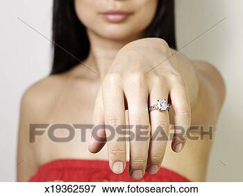 Picture - woman showing 
engagement ring 
on finger, close-up. 
fotosearch - search 
stock photos, 
pictures, images, 
and photo clipart