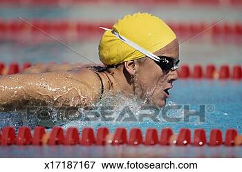 Picture - woman swimming 
butterfly stroke, 
side view. fotosearch 
- search stock 
photos, pictures, 
images, and photo 
clipart