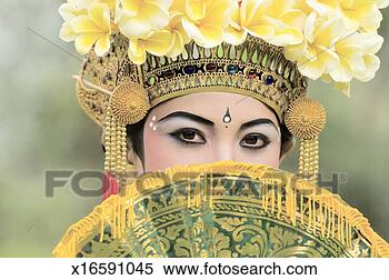 Stock Image - young balinese 
girl (13-14) dancer 
behind fan, portrait. 
fotosearch - search 
stock photos, 
pictures, images, 
and photo clipart