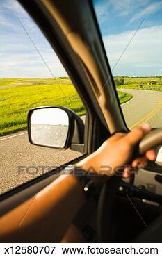 Picture - young woman driving 
car, vehicle interior, 
differential focus. 
fotosearch - search 
stock photos, 
pictures, images, 
and photo clipart