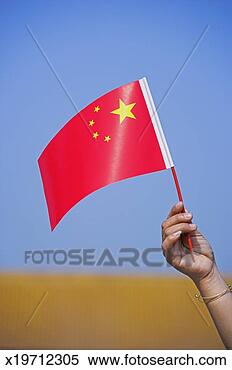 Stock Image - china, beijing, 
woman holding 
chinese flag, 
close up of flag. 
fotosearch - search 
stock photos, 
pictures, images, 
and photo clipart