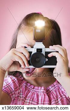 Stock Photo - girl (8-9) taking 
picture with old 
fashioned camera, 
close-up. fotosearch 
- search stock 
photos, pictures, 
images, and photo 
clipart