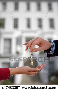 Picture - man handing house 
keys to woman, 
close up of hands. 
fotosearch - search 
stock photos, 
pictures, images, 
and photo clipart