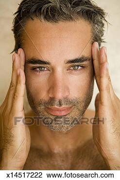 Stock Photo - portrait of mid 
adult man with 
hands on temples, 
close-up. fotosearch 
- search stock 
photos, pictures, 
images, and photo 
clipart