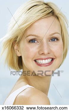 Stock Photo - young woman smiling, 
close up, studio 
shot, close up. 
fotosearch - search 
stock photos, 
pictures, images, 
and photo clipart
