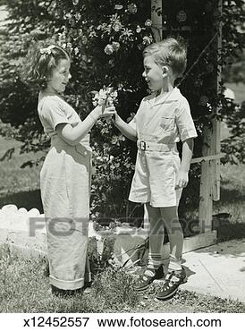 Picture - boy (4-5) giving 
girl (4-5) flowers, 
(b&w). fotosearch 
- search stock 
photos, pictures, 
images, and photo 
clipart