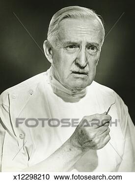 Stock Photography - dentist holding 
medical instrument, 
posing in studio, 
(b&w), portrait. 
fotosearch - search 
stock photos, 
pictures, images, 
and photo clipart