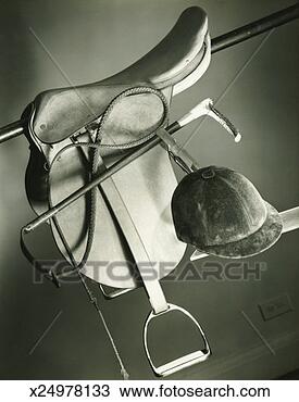 Stock Photo - saddle with stirrups, 
crop and hat, 
(b&w), close-up. 
fotosearch - search 
stock photos, 
pictures, images, 
and photo clipart