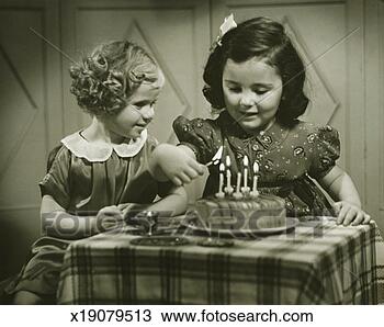 Stock Photo - two girls (3-4), 
 (4-5) sitting 
at small table 
with birthday 
cake. fotosearch 
- search stock 
photos, pictures, 
images, and photo 
clipart