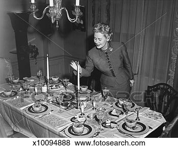 Stock Photo - woman lighting 
up candle, table 
ready for dessert, 
(b&w). fotosearch 
- search stock 
photos, pictures, 
images, and photo 
clipart
