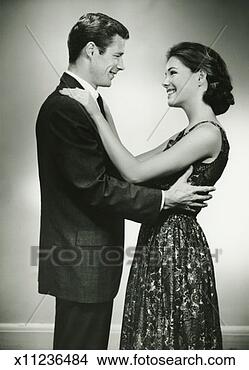 Stock Photo - young couple standing 
face to face, 
smiling, in studio, 
(b&w). fotosearch 
- search stock 
photos, pictures, 
images, and photo 
clipart