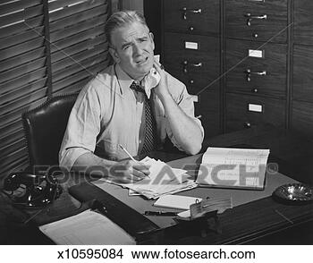 Stock Photo - tired man working 
at desk (b&w), 
portrait. fotosearch 
- search stock 
photos, pictures, 
images, and photo 
clipart