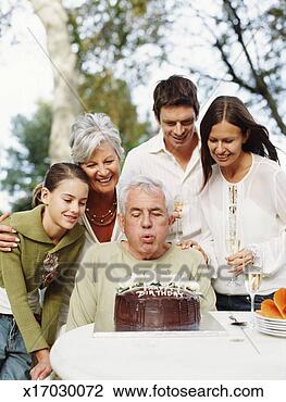 Stock Photo - multi generational 
family having 
birthday celebration, 
smiling. fotosearch 
- search stock 
photos, pictures, 
images, and photo 
clipart