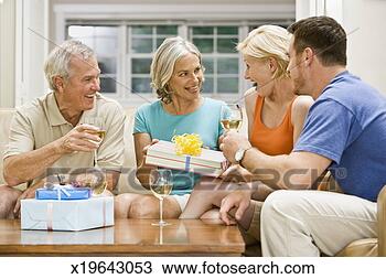 Stock Photo - family giving 
gifts and drinking 
wine. fotosearch 
- search stock 
photos, pictures, 
images, and photo 
clipart