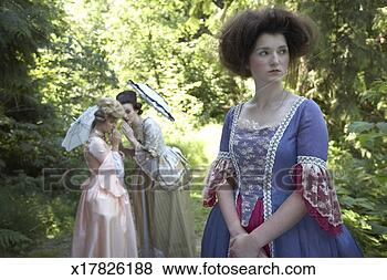 Stock Photo - three women in 
period dresses, 
 one standing 
in front of two. 
fotosearch - search 
stock photos, 
pictures, images, 
and photo clipart