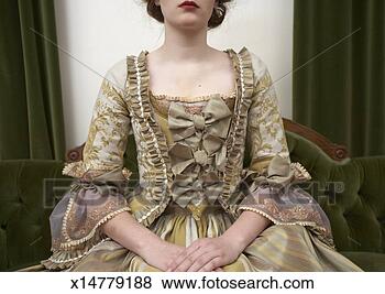 Stock Photo - woman in period 
dress sitting 
on couch, mid 
section. fotosearch 
- search stock 
photos, pictures, 
images, and photo 
clipart