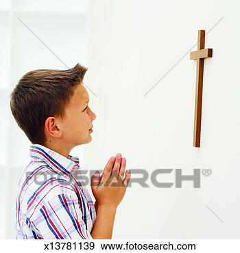 Stock Photograph - boy (8-9) praying. 
fotosearch - search 
stock photos, 
pictures, images, 
and photo clipart