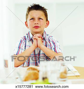 Stock Photography - boy (8-9) praying. 
fotosearch - search 
stock photos, 
pictures, images, 
and photo clipart