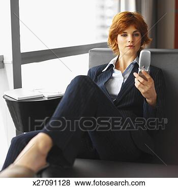 Stock Photo - close-up of businesswoman 
holding mobile 
phone. fotosearch 
- search stock 
photos, pictures, 
images, and photo 
clipart