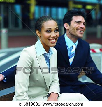 Stock Image - close-up of two 
business executives 
sitting on bench. 
fotosearch - search 
stock photos, 
pictures, images, 
and photo clipart