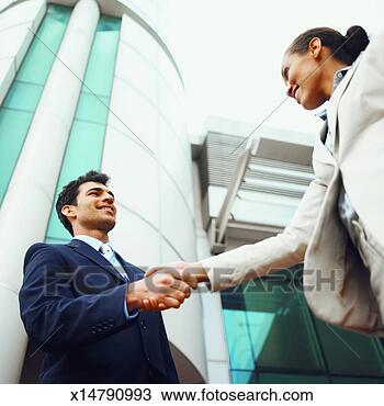 Stock Photo - low angle view 
of two business 
executives shaking 
hands. fotosearch 
- search stock 
photos, pictures, 
images, and photo 
clipart